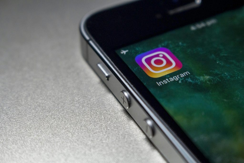 pexels-photo-248533-248533 Close-up image of a smartphone screen displaying the Instagram app icon, emphasizing modern technology.